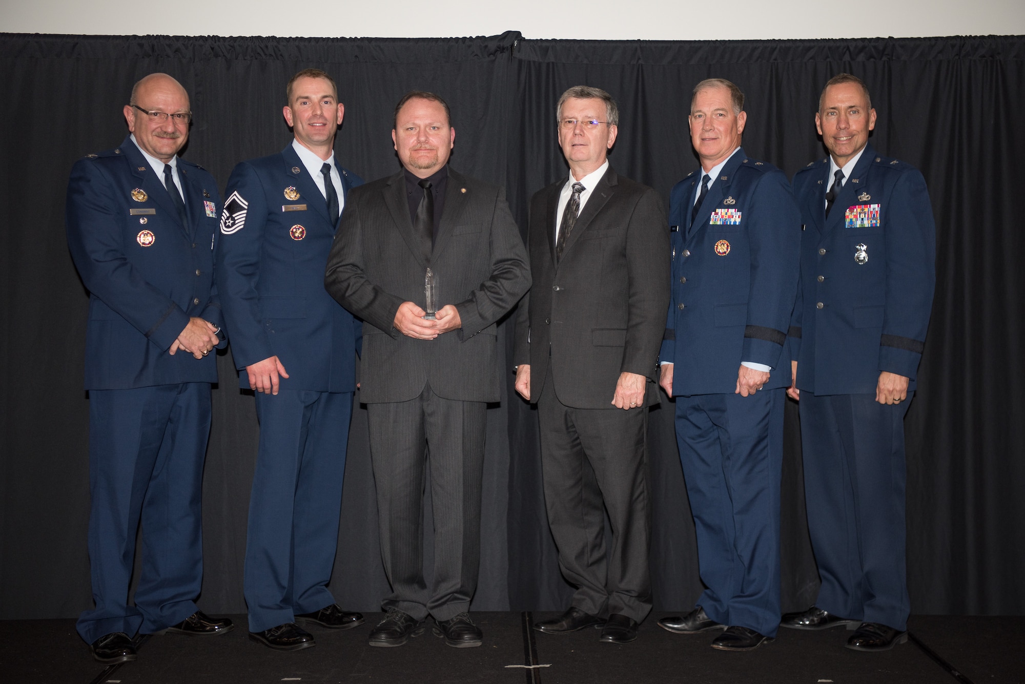 Shane Braziel, National Guard Bureau/Air National Guard Security Forces Division, Joint Base Andrews, Maryland, receives the Air National Guard Higher Headquarters Staff Civilian of 2017 Award at the 2018 Air National Guard Security Forces Squadron Dinner and Awards Banquet at the National Center for Employee Development Conference Center in Norman, Oklahoma, Sept. 12, 2018. Every year, leadership from all of the Air National Guard security forces squadrons meet in one place to discuss past, current and upcoming topics that impact the career field, as well as recognize outstanding security forces Airmen. (U.S. Air National Guard Photo by Staff Sgt. Kasey M. Phipps)