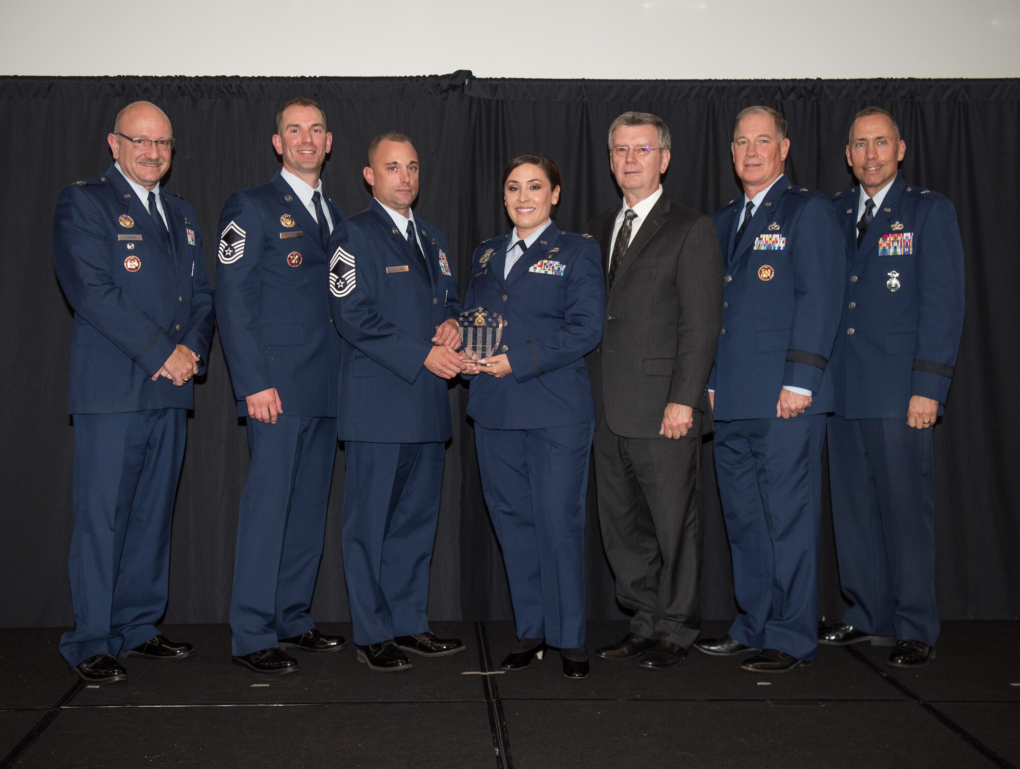 Capt. Erika Jaramillo and Chief Master Sgt. James Mulcahey, 162nd Security Forces Squadron, Tucson, Arizona, receive the Outstanding Air Reserve Component Security Forces Unit of 2017 Award at the 2018 Air National Guard Security Forces Squadron Dinner and Awards Banquet at the National Center for Employee Development Conference Center in Norman, Oklahoma, Sept. 12, 2018. Every year, leadership from all of the Air National Guard security forces squadrons meet in one place to discuss past, current and upcoming topics that impact the career field, as well as recognize outstanding security forces Airmen. (U.S. Air National Guard Photo by Staff Sgt. Kasey M. Phipps)