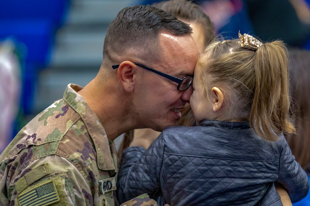 A soldier greets his daughter.