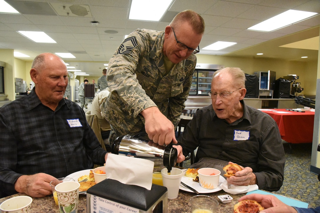 Chief Master Sgt. Jeff Miller pours coffee for retired Chief Master Sgt. Fred Quam at the annual retiree breakfast get-together at the North Dakota Air National Guard Base, Fargo, N.D., Oct. 3, 2018.