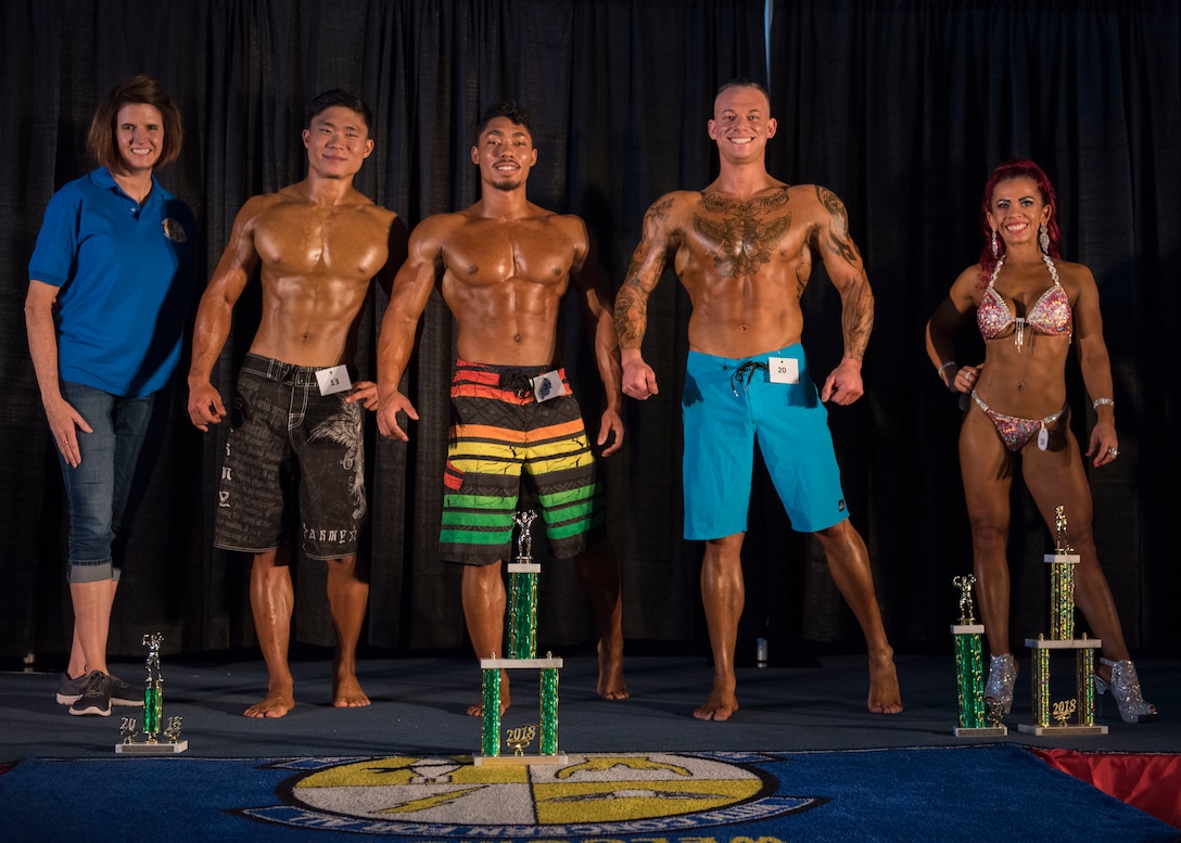 U.S. Air Force Lt. Col. Laura King, 633rd Force Support Squadron commander poses with the winners of the Langley Classics Bodybuilding competition at Joint Base Langley-Eustis, Virginia, Sept. 29, 2018.