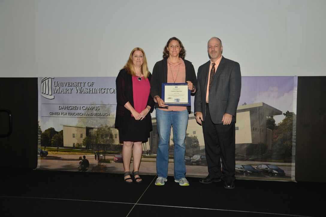 IMAGE: Jennifer Wright receives her certificate of appreciation from Naval Surface Warfare Center Dahlgren Division (NSWCDD) Acting Chief of Staff Terri Gray and Acting Deputy Technical Director Chris Clifford at the 2018 NSWCDD Academic Recognition Ceremony.