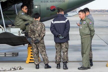 Republic of Korea Air Force Airmen await to unload cargo from their ROK C-130 Hercules, during Red Flag-Alaska 18-4 at Joint Base Elmendorf-Richardson, Alaska, Oct. 1, 2018. Red Flag-Alaska is a Pacific Air Forces-directed field training exercise for U.S. and international forces flown under simulated air combat conditions. The exercises are focused on improving the combat readiness of U.S. and international forces and providing training for units preparing for air expeditionary force taskings.