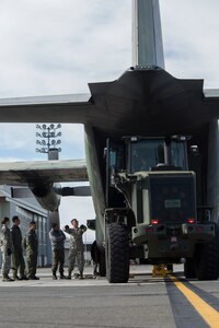 U.S. Air Force Staff Sgt. Jonathan Armstrong, a documented cargo noncommissioned officer in charge with the 374th Logistics Readiness Squadron, Yokota Air Base, Japan, gives instructions to Senior Airman Thomas Scholtz, a ground transportation vehicle operator with the 35th Logistics Readiness Squadron, Misawa Air Base, Japan, during Red Flag-Alaska 18-4 at Joint Base Elmendorf-Richardson, Alaska, Oct. 1, 2018. Red Flag-Alaska is a Pacific Air Forces-directed field training exercise for U.S. and international forces flown under simulated air combat conditions. The exercises are focused on improving the combat readiness of U.S. and international forces and providing training for units preparing for air expeditionary force taskings.