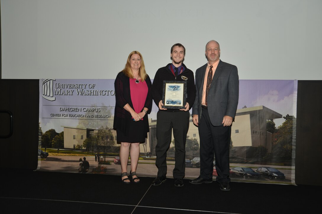 IMAGE: DAHLGREN, Va. (Sept. 21, 2018) – Conor O’Neill receives his certificate of achievement from Naval Surface Warfare Center Dahlgren Division (NSWCDD) Acting Chief of Staff Terri Gray and Acting Deputy Technical Director Chris Clifford at the 2018 NSWCDD Academic Recognition Ceremony. (U.S. Navy photo by George Smith/Released)