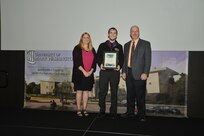 IMAGE: DAHLGREN, Va. (Sept. 21, 2018) – Conor O’Neill receives his certificate of achievement from Naval Surface Warfare Center Dahlgren Division (NSWCDD) Acting Chief of Staff Terri Gray and Acting Deputy Technical Director Chris Clifford at the 2018 NSWCDD Academic Recognition Ceremony. (U.S. Navy photo by George Smith/Released)