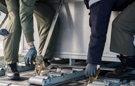 Republic of Korea Air Force Chief Master Sgt. Wooseop Lim and ROKAF Master Sgt. Soyoung Lee, loadmasters assigned to the 15th Special Missions Wing, tighten the cargo straps, during Red Flag-Alaska 18-4 at Joint Base Elmendorf-Richardson, Alaska, Oct. 1, 2018. Red Flag-Alaska is a Pacific Air Forces-directed field training exercise for U.S. and international forces flown under simulated air combat conditions. The exercises are focused on improving the combat readiness of U.S. and international forces and providing training for units preparing for air expeditionary force taskings.