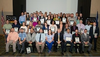 IMAGE: DAHLGREN, Va. - Naval Surface Warfare Center Dahlgren Division (NSWCDD) employees honored at the command's 2018 academic recognition ceremony are pictured after the event where they were commended for successfully taking on the challenges of balancing work and family responsibilities with academics to obtain certifications or degrees. In addition to core engineering disciplines – mechanical, electrical, and systems engineering – this year's graduates earned degrees in diverse fields such as defense and strategic studies, computational sciences and informatics, cybersecurity, engineering psychology, human resource management, accounting, and aerospace engineering, and leadership studies.