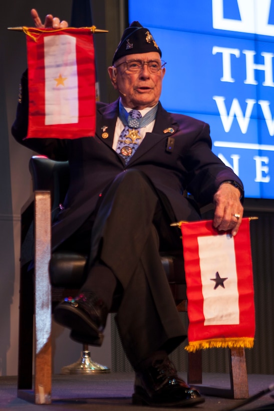 Retired Chief Warrant Officer 4 Hershel “Woody” Williams, the last surviving Medal of Honor recipient from the Battle of Iwo Jima, explains the importance behind the Gold Star Flag and the Blue Star Flag to the attendees of his 95th birthday party at the National World War II Museum, Oct. 2, 2018. Williams established the “Hershel Woody Williams Medal of Honor Foundation” in 2010. The foundation encourages the establishment of Gold Star family Memorial Monuments. (U.S. Marine Corps photo by Lance Cpl. Tessa D. Watts)