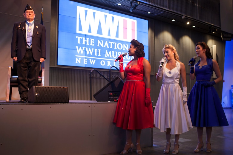The Victory Belles, a vocal trio, sing the Marines’ Hymn during the 95th birthday party of retired Chief Warrant Officer 4 Hershel “Woody” Williams, the last surviving Medal of Honor recipient of the Battle of Iwo Jima, at the National World War II Museum, Oct. 2, 2018. Williams enlisted in the Marine Corps Reserve in 1943 and served in the Battle of Iwo Jima with the 21st Marines, 3rd Marine Division in 1945. (U.S. Marine Corps photo by Lance Cpl Tessa D. Watts)