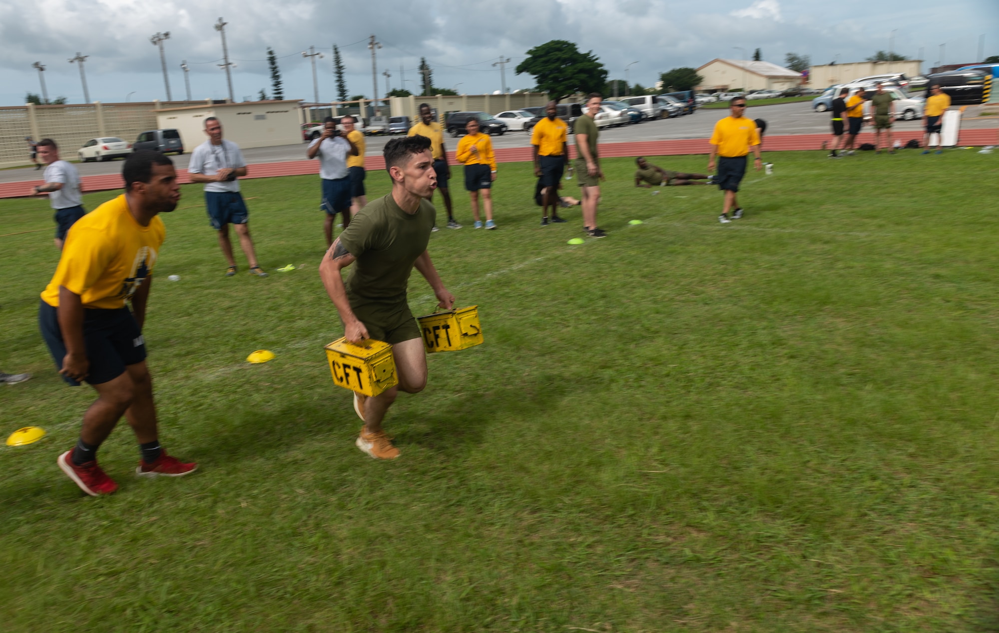 U.S. Navy Petty Officer 2nd Class Jesse Pedrero motivates U.S. Marine Corps Sgt. Cory Gargus, both Okinawa Joint Experience Green Team students, while he carries ammo cans during the Okinawa Joint Fitness Challenge Sept. 26, 2018, at Kadena Air Base, Japan. Service members from the Army, Navy, Air Force and Marine Corps were equally broken up into four classes to provide a joint learning environment. (U.S. Air Force photo by Staff Sgt. Micaiah Anthony)