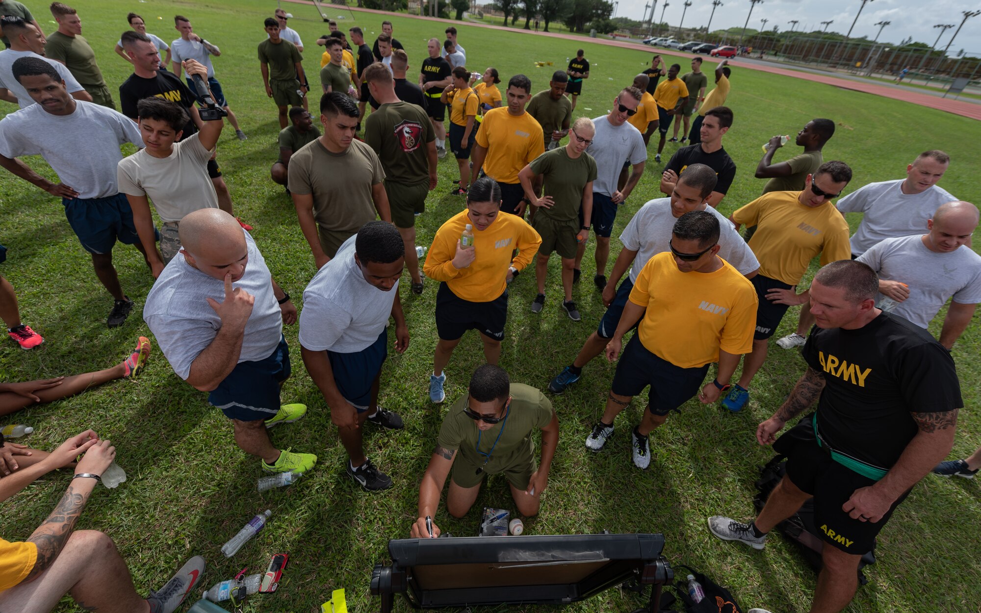 U.S. Marine Corps 1st Sgt. Michael Collins, Okinawa Joint Experience instructor, updates each team’s score during the Okinawa Joint Fitness Challenge Sept. 26, 2018, at Kadena Air Base, Japan. After calculating points from the push-up challenge, combat fitness challenge and tug-of-war, the Green Team was determined the winner of the OJFC. (U.S. Air Force photo by Staff Sgt. Micaiah Anthony)