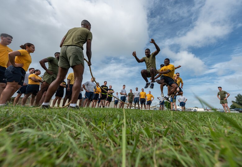 U.S. Soldiers, Sailors, Marines and Airmen take turns jumping over a rope during the Okinawa Joint Fitness Challenge Sept. 26, 2018, at Kadena Air Base, Japan. The jump rope challenge required all 48 students to jump over the rope while it was in motion. If the rope touched a student while they were jumping over, or if the rope stopped, the students would have to start over again. (U.S. Air Force photo by Staff Sgt. Micaiah Anthony)
