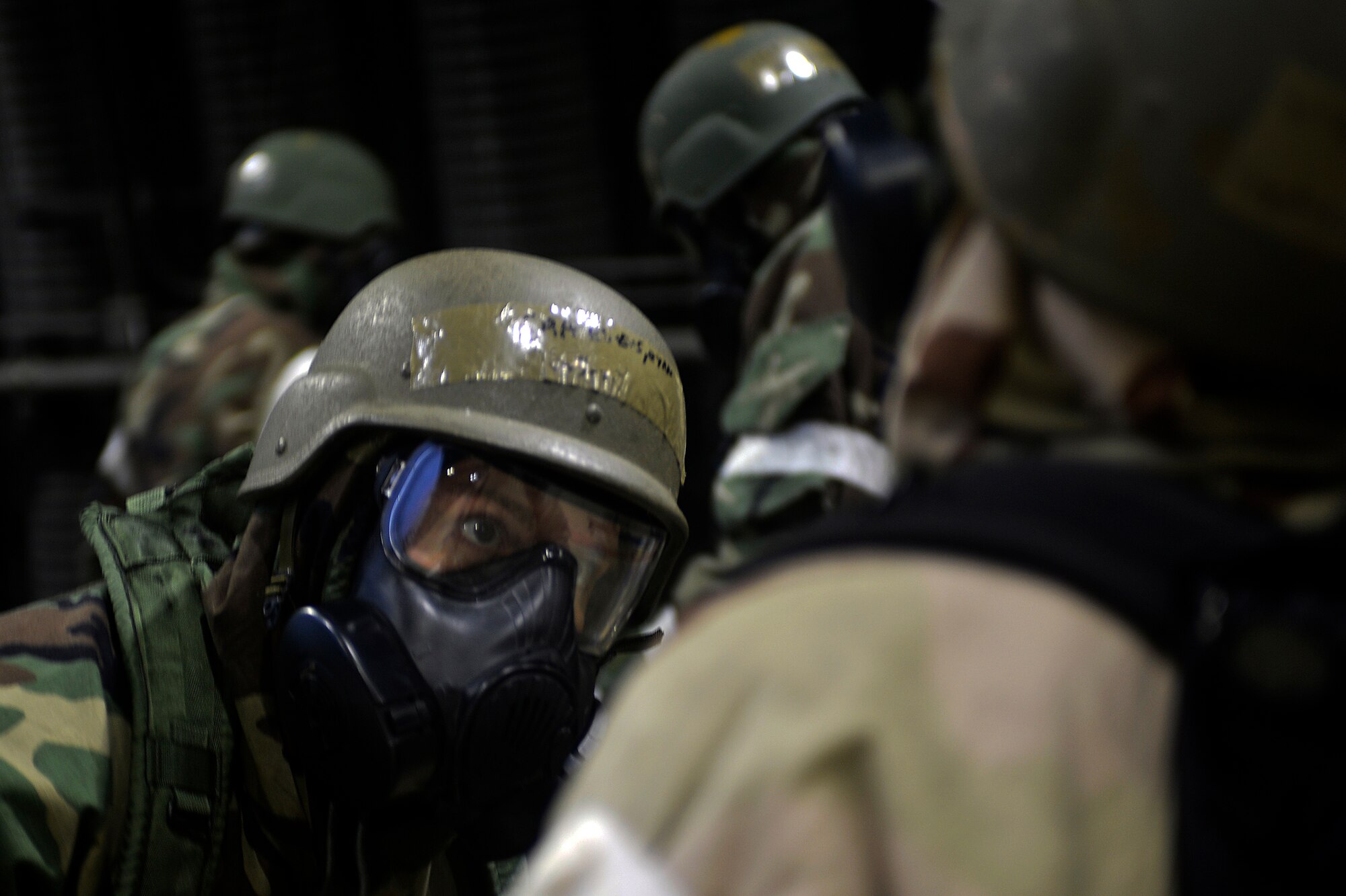 48th Fighter Wing Airmen don mission-oriented protective posture gear during a readiness exercise at Royal Air Force Lakenheath, England, Oct. 2, 2018. Exercise scenarios were designed to emphasize the importance of combat skills effectiveness training and ensure wing Airmen are fully prepared for potential contingencies. (U.S. Air Force photo by Master Sgt. Eric Burks) (Portions of this image have been obscured to protect operational security)