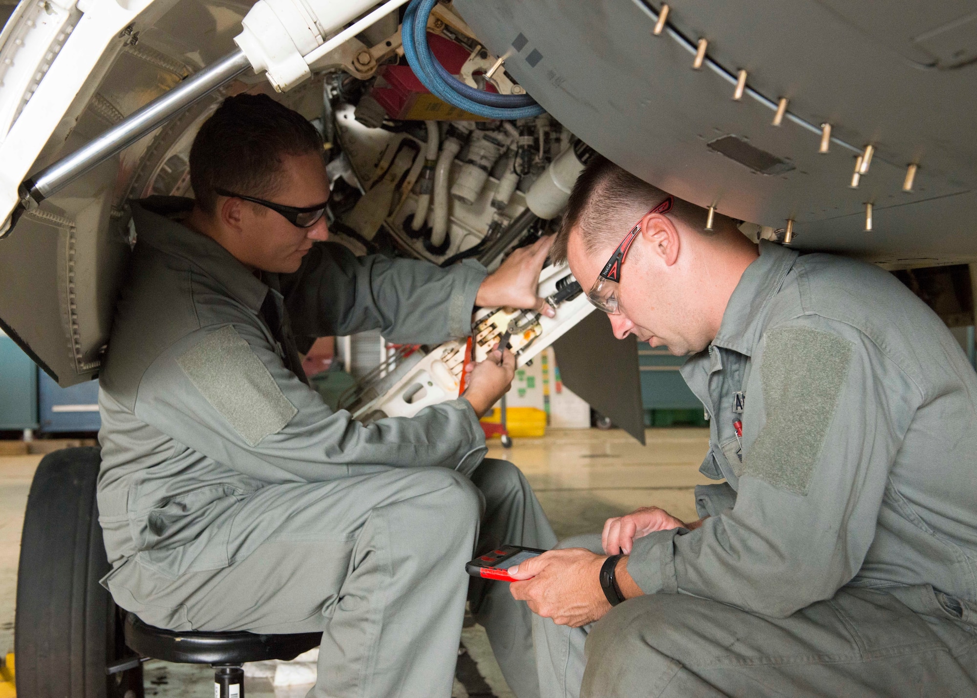 U.S. Air Force Airman 1st Class Kevin Davis and Master Sgt. Casey Drew, aircraft maintainers assigned to the 158th Fighter Wing, look over technical data while performing a check during a phase inspection at the Vermont Air National Guard Base, August 1, 2018. Aircraft 328 was the last F-16 to undergo a phase inspection as the unit transitions to the F-35 Lightning II in fall of 2019. (U.S. Air National Guard photo by 2nd. Lt. Chelsea Clark)