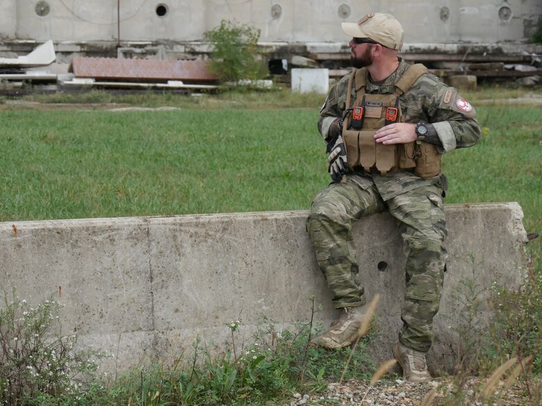 Instructor John Passmore watches as the Tech Warrior participants prepare for a confrontation at one of the Forward Operation Bases. (U.S. Air Force photo/Kenneth McNulty)