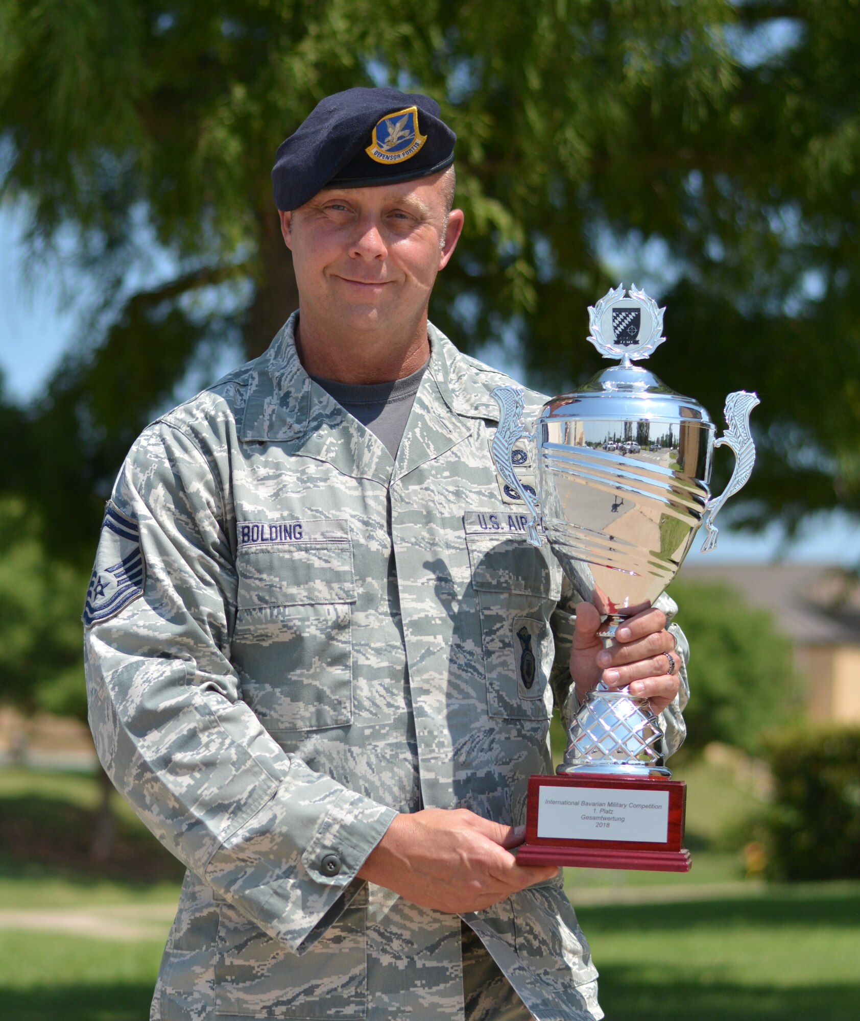 Senior Master Sgt. Chad Bolding, 507th Security Forces Squadron operations superintendent, holds the International Bavarian Military Competition first place trophy Aug. 3, 2018, at Tinker Air Force Base, Oklahoma. Bolding was the captain of the Air Force Reserve Command team who won first place at the international competition. (U.S. Air Force photo by Tech. Sgt. Samantha Mathison)