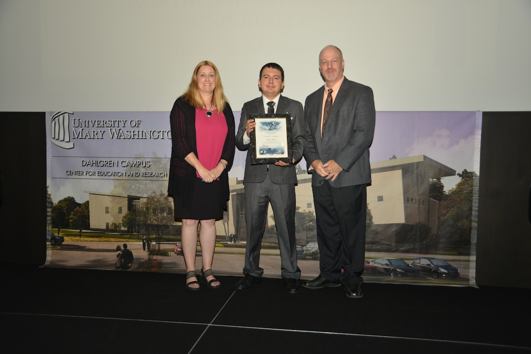 IMAGE: DAHLGREN, Va. (Sept. 21, 2018) – Daniel Apolinar receives his certificate of achievement from Naval Surface Warfare Center Dahlgren Division (NSWCDD) Acting Chief of Staff Terri Gray and Acting Deputy Technical Director Chris Clifford at the 2018 NSWCDD Academic Recognition Ceremony.