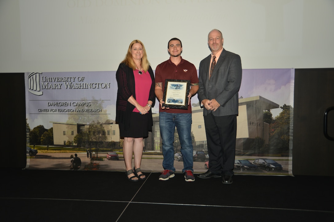 IMAGE: DAHLGREN, Va. (Sept. 21, 2018) – David Frederickson receives his certificate of achievement from Naval Surface Warfare Center Dahlgren Division (NSWCDD) Acting Chief of Staff Terri Gray and Acting Deputy Technical Director Chris Clifford at the 2018 NSWCDD Academic Recognition Ceremony.