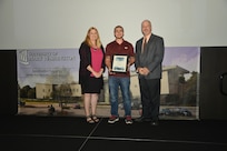 IMAGE: DAHLGREN, Va. (Sept. 21, 2018) – David Frederickson receives his certificate of achievement from Naval Surface Warfare Center Dahlgren Division (NSWCDD) Acting Chief of Staff Terri Gray and Acting Deputy Technical Director Chris Clifford at the 2018 NSWCDD Academic Recognition Ceremony.