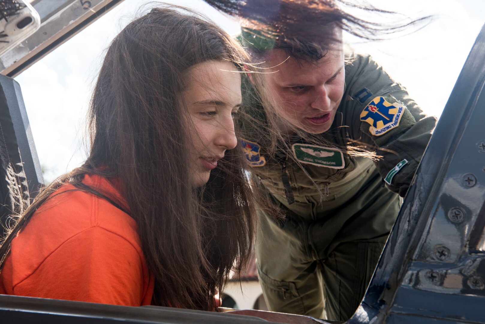 Charlotte Elmore, University of Texas San Antonio Women’s Basketball Team player, sits in the cockpit of a T-38C Talon while Capt. Josh Thompson, 560th Flying Training Squadron instructor pilot, explains the controls Sept. 25, 2018, at Joint Base San Antonio-Randolph, Texas. The T-38C Talon is a twin-engine, high-altitude, supersonic jet trainer used in a variety of roles because of its design, economy of operations, ease of maintenance, high performance and exceptional safety record. (U.S. Air Force photo by Senior Airman Stormy Archer)