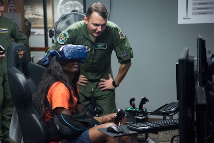 Tasharian Robinson, University of Texas San Antonio Women’s Basketball Team player, operates a virtual reality flight simulator with Capt. Jay Moore, 560th Flying Training Squadron instructor pilot, Sept. 25, 2018, at Joint Base San Antonio-Randolph, Texas. The 560th Flying Training Squadron qualifies fighter and bomber pilots as instructor pilots in the T-38C Talon. (U.S. Air Force photo by Senior Airman Stormy Archer)