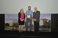 IMAGE: DAHLGREN, Va. (Sept. 21, 2018) – Brian Bowser receives his certificate of achievement from Naval Surface Warfare Center Dahlgren Division (NSWCDD) Acting Chief of Staff Terri Gray and Acting Deputy Technical Director Chris Clifford at the 2018 NSWCDD Academic Recognition Ceremony.