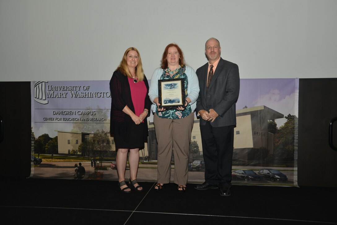 IMAGE: DAHLGREN, Va. (Sept. 21, 2018) – Evelyn Peyton receives her certificate of achievement from Naval Surface Warfare Center Dahlgren Division (NSWCDD) Acting Chief of Staff Terri Gray and Acting Deputy Technical Director Chris Clifford at the 2018 NSWCDD Academic Recognition Ceremony.