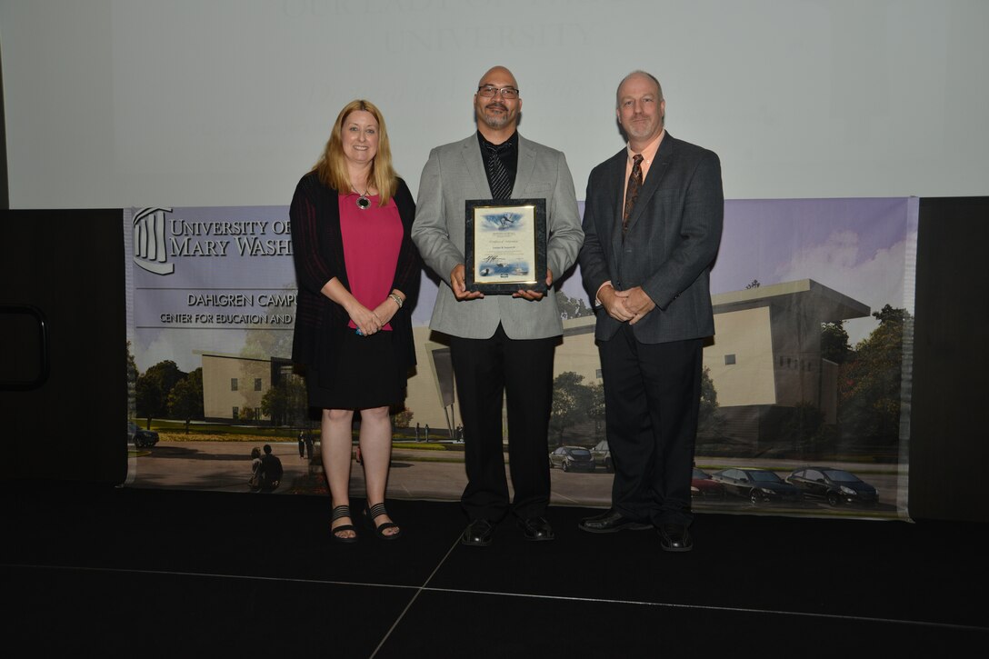 IMAGE: DAHLGREN, Va. (Sept. 21, 2018) – Lutcher Samuel III receives his certificate of achievement from Naval Surface Warfare Center Dahlgren Division (NSWCDD) Acting Chief of Staff Terri Gray and Acting Deputy Technical Director Chris Clifford at the 2018 NSWCDD Academic Recognition Ceremony.