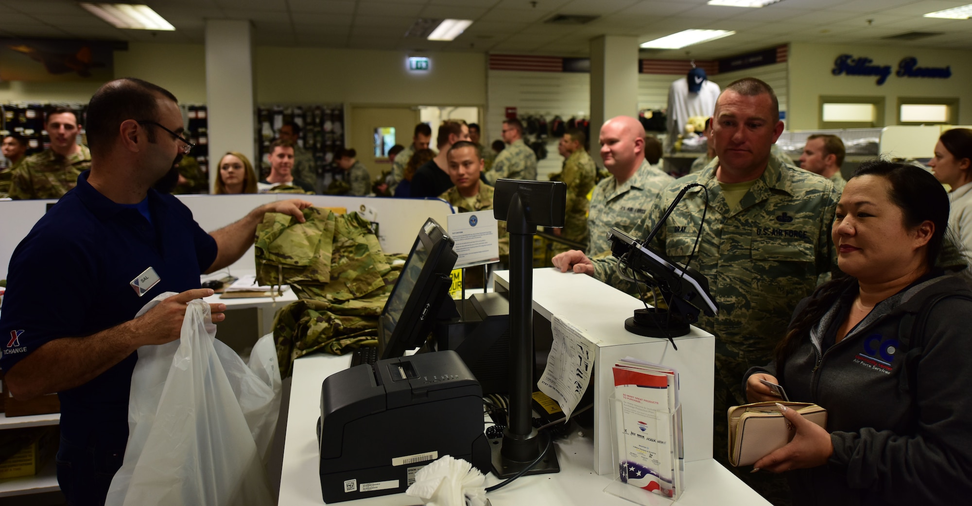 An AAFES employee helps Airmen check out at Military Clothing Sales on Aviano Air Base, Oct. 1, 2018.
