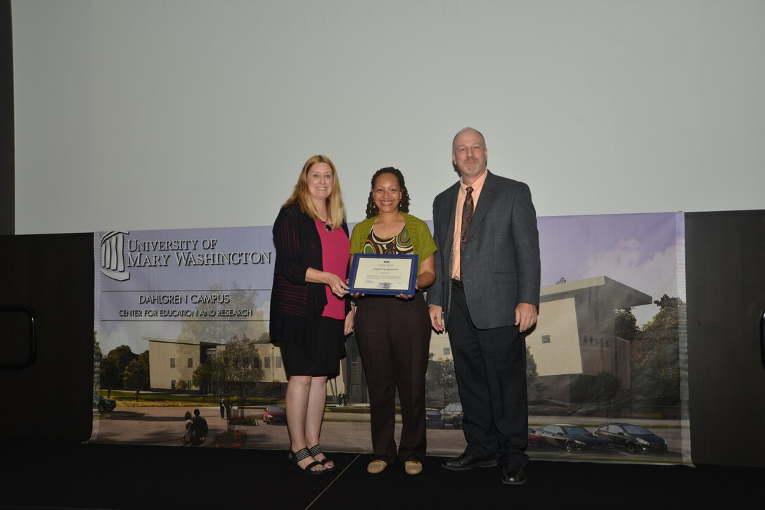 IMAGE: DAHLGREN, Va. (Sept. 21, 2018) – Kim Booker receives her certificate of appreciation from Naval Surface Warfare Center Dahlgren Division (NSWCDD) Acting Chief of Staff Terri Gray and Acting Deputy Technical Director Chris Clifford at the 2018 NSWCDD Academic Recognition Ceremony.