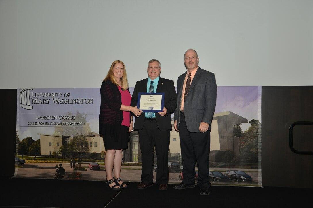 IMAGE: DAHLGREN, Va. (Sept. 21, 2018) – Gregory Johnson receives his certificate of appreciation from Naval Surface Warfare Center Dahlgren Division (NSWCDD) Acting Chief of Staff Terri Gray and Acting Deputy Technical Director Chris Clifford at the 2018 NSWCDD Academic Recognition Ceremony.