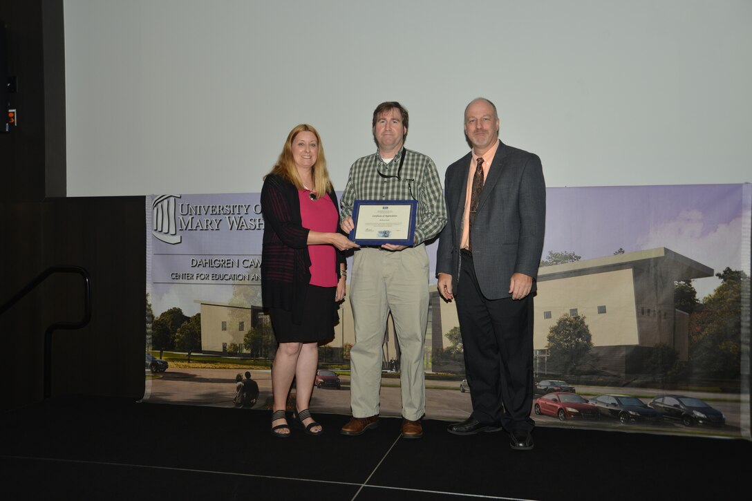 IMAGE: DAHLGREN, Va. (Sept. 21, 2018) – Michael Kelly receives his certificate of appreciation from Naval Surface Warfare Center Dahlgren Division (NSWCDD) Acting Chief of Staff Terri Gray and Acting Deputy Technical Director Chris Clifford at the 2018 NSWCDD Academic Recognition Ceremony.