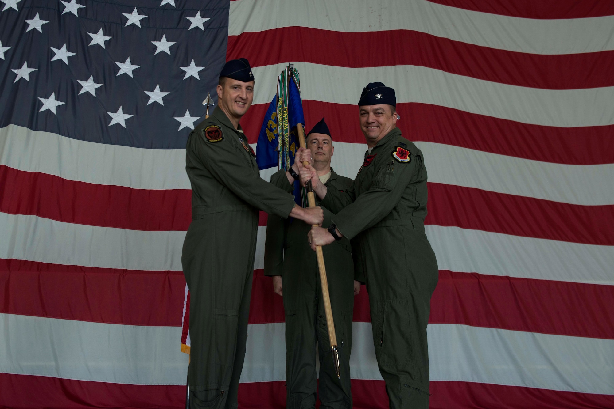 U.S. Air Force Col. Travis Norton, 25th Attack Group (ATKG) commander, right, receives the 25th ATKG guidon from Col. Julian Cheater, 432nd Wing and 432nd Expeditionary Wing commander, left, at Shaw Air Force Base, S.C., Oct. 2, 2018.