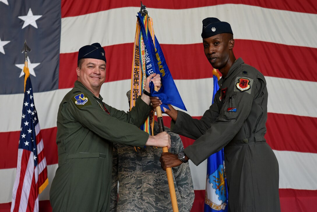 U.S. Air Force Col Travis Norton, 25th Attack Group commander passes the 482nd Attack Squadron (ATKS) guidon to Lt. Col. Andre, 482nd ATKS commander at Shaw Air Force Base, S.C., Oct. 3, 2018.
