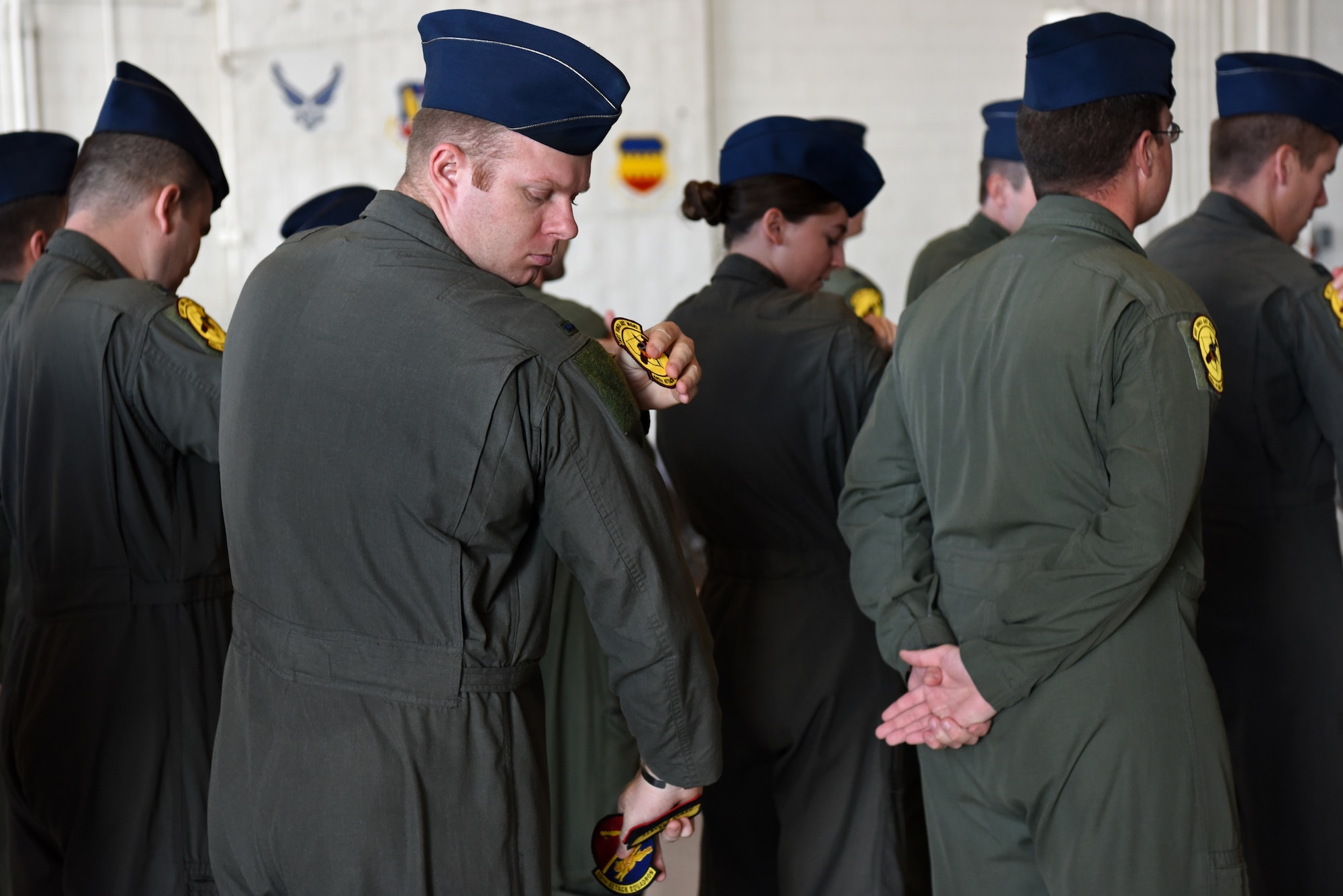 U.S. Air Force Airmen place 482nd Attack Squadron patches on their flight suits at Shaw Air Force Base, S.C., Oct. 3, 2018