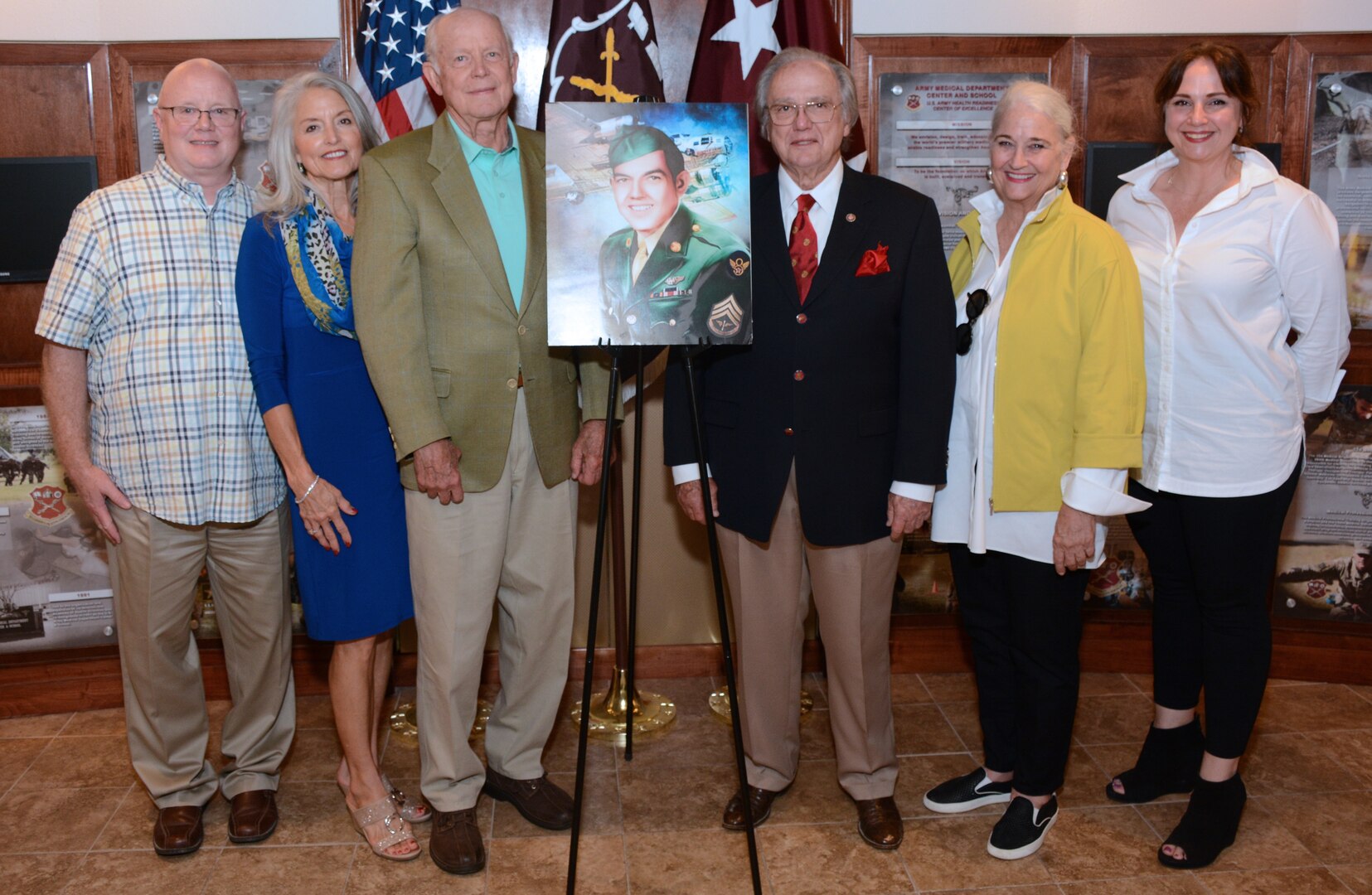 (From left) Bubba Brice, Frances Younger, John F. Younger Jr., Charles M. Younger, "Chica" Younger and Galeana Younger pose with a portrait of Bobby Joe Younger, a World War II bombardier killed in action in 1944. The family were presented with Younger’s military awards posthumously received from the Department of the Army.