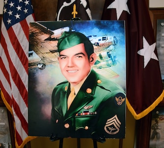 A portrait by Colin Kimball of Bobby J. Younger, with B-17 and Ball Belly Turret depicted. The family of Younger, a World War II bombardier killed in action in 1944, were presented with Younger’s military awards posthumously received from the Department of the Army.