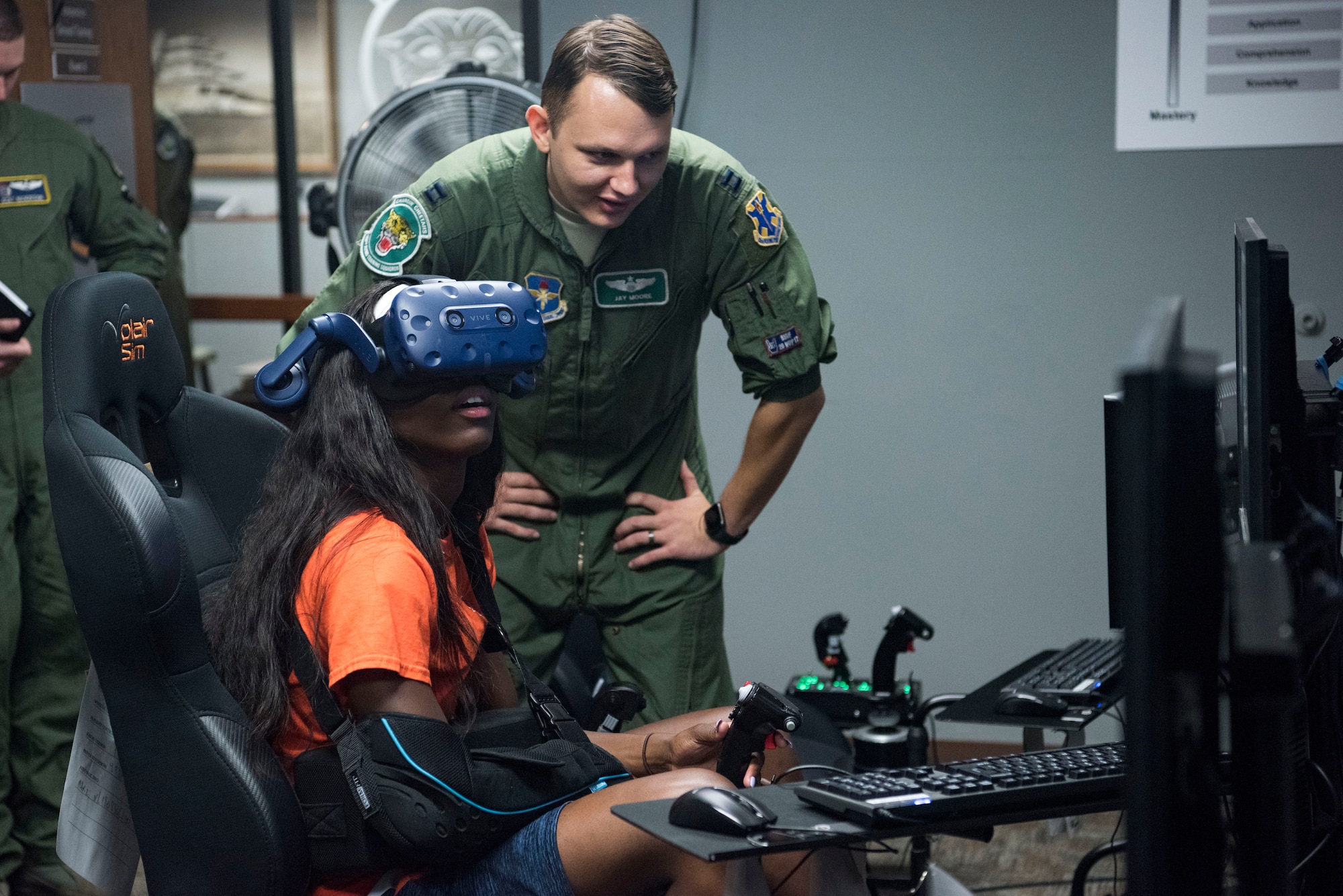 Tasharian Robinson, University of Texas San Antonio Women’s Basketball Team player, operates a virtual reality flight simulator with Capt. Jay Moore, 560th Flying Training Squadron instructor pilot, Sept. 25, 2018, at Joint Base San Antonio-Randolph, Texas. The 560th Flying Training Squadron qualifies fighter and bomber pilots as instructor pilots in the T-38C Talon. (U.S. Air Force photo by Senior Airman Stormy Archer)