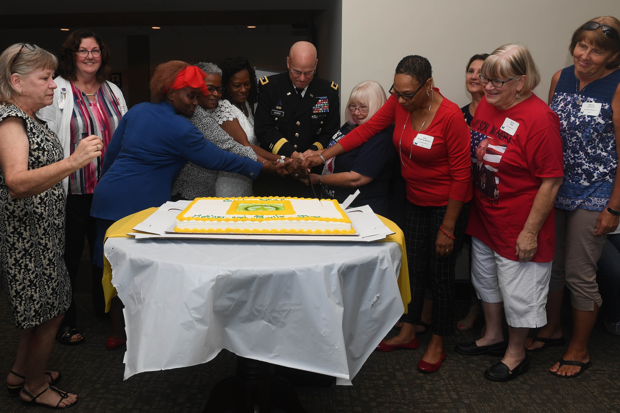 U.S. Army Maj. Gen. John George, Army Capabilities Integration Center deputy director, cuts a cake in honor of Gold Star Mother’s Day at Joint Base Langley-Eustis, Virginia, Sept. 30, 2018. The Survivor Outreach Services is an Army-wide program that provides support to families of deceased service members. (U.S. Air Force photo by Senior Airman Derek Seifert)