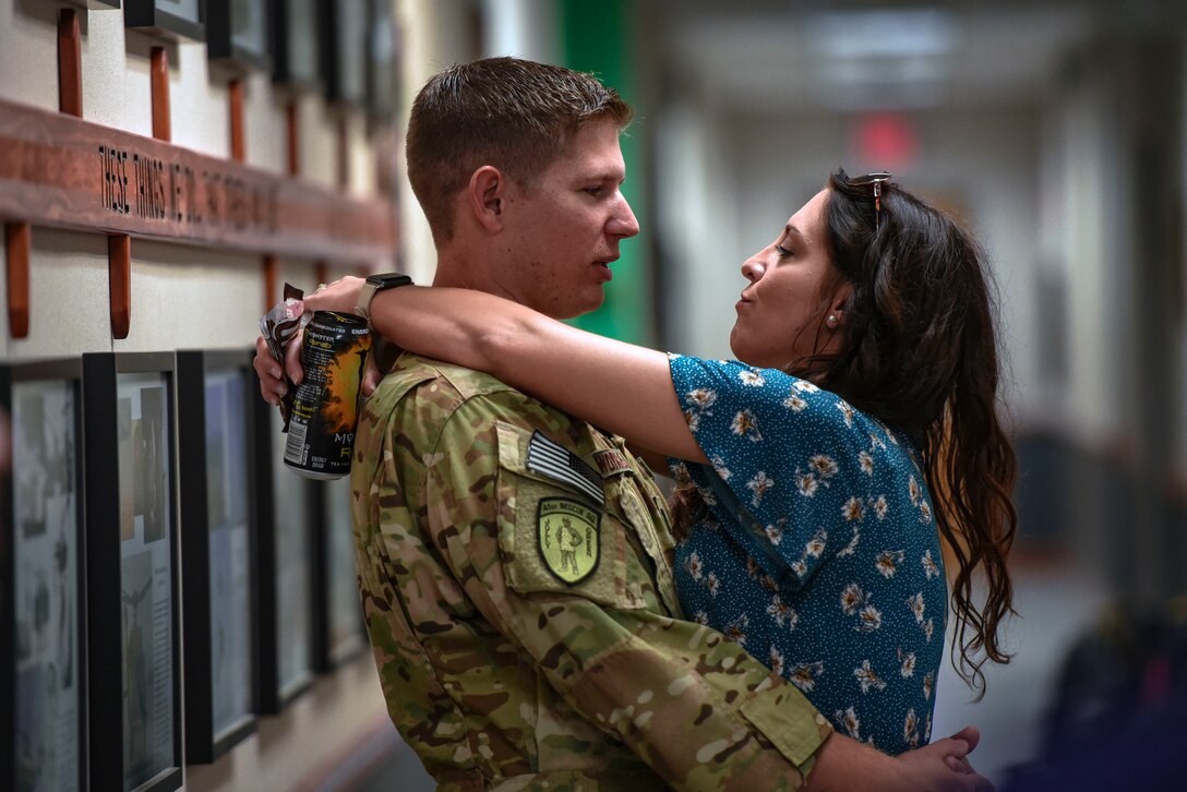 Capt. Travis Worrell, 41st Rescue Squadron HH-60G Pave Hawk helicopter pilot, embraces his wife Brittany prior to a deployment, Sept. 26, 2018, at Moody Air Force Base, Ga. The 41st RQS and the 41st Helicopter Maintenance Unit will provide combat search and rescue capabilities and maintenance operations in a forward deployed location. (U.S. Air Force photo by Senior Airman Greg Nash)
