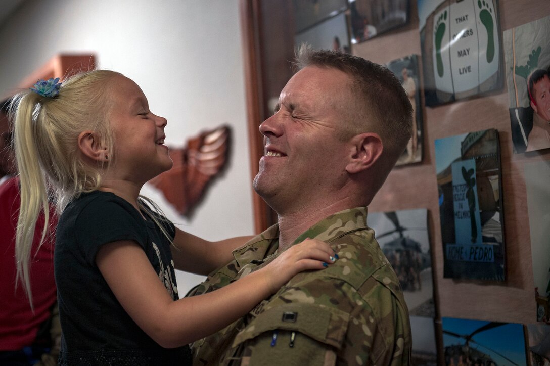 Capt. Casey Doane, 41st Rescue Squadron HH-60G Pave Hawk helicopter pilot, embraces his daughter prior to a deployment, Sept. 26, 2018, at Moody Air Force Base, Ga. The 41st RQS and the 41st Helicopter Maintenance Unit will provide combat search and rescue capabilities and maintenance operations in a forward deployed location. (U.S. Air Force photo by Senior Airman Greg Nash)