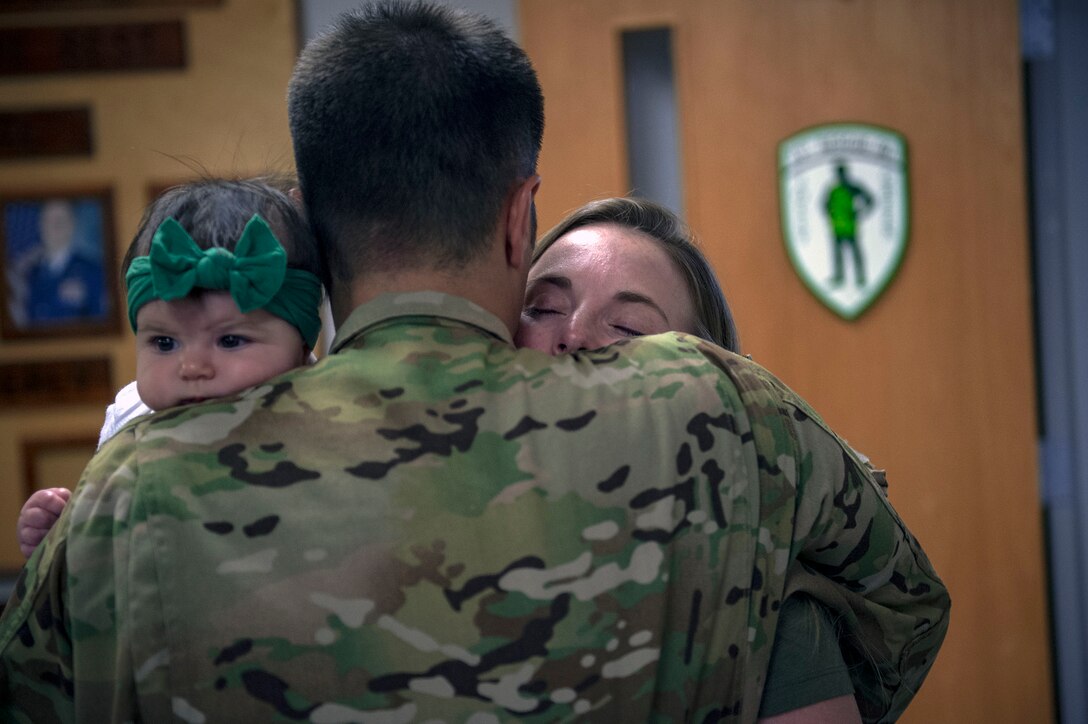 Capt. Philip Veltre, 41st Rescue Squadron HH-60G Pave Hawk helicopter pilot, hugs his wife Justine and daughter Lin, prior to a deployment, Sept. 26, 2018, at Moody Air Force Base, Ga. The 41st RQS and the 41st Helicopter Maintenance Unit will provide combat search and rescue capabilities and maintenance operations in a forward deployed location. (U.S. Air Force photo by Senior Airman Greg Nash)