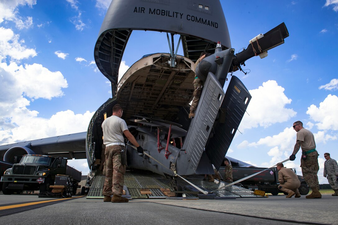 Maintainers from the 41st Helicopter Maintenance Unit, load an HH-60G Pave Hawk helicopter into a C-5 Galaxy, prior to a deployment, Sept. 26, 2018, at Moody Air Force Base, Ga. The 41st RQS and the 41st Helicopter Maintenance Unit will provide combat search and rescue capabilities and maintenance operations in a forward deployed location. (U.S. Air Force photo by Senior Airman Greg Nash)