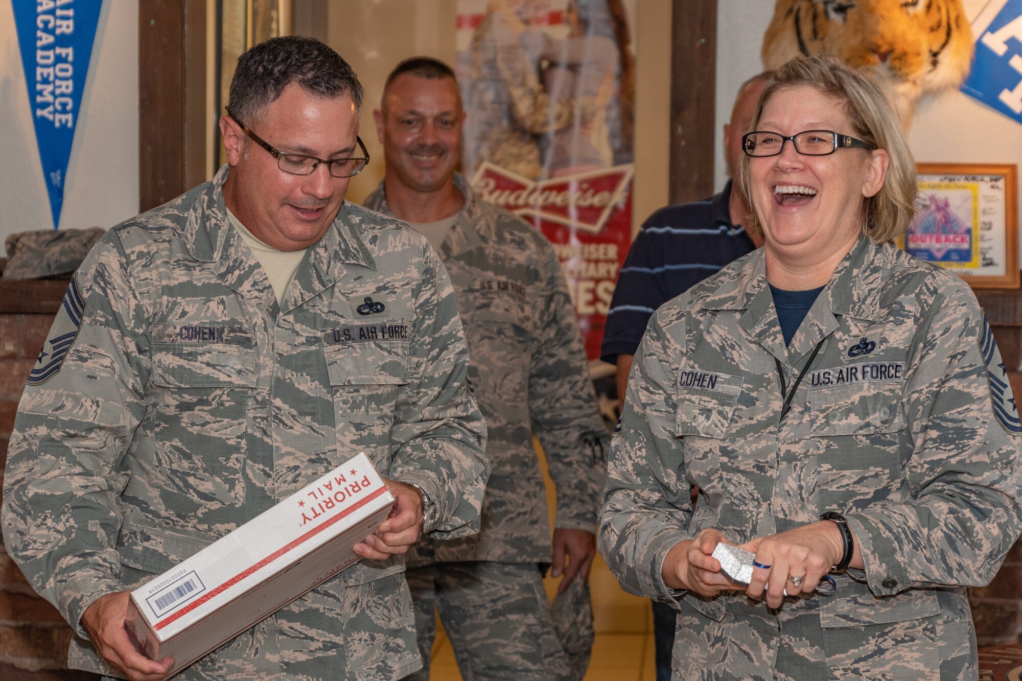 U.S. Air Force Chief Master Sgt. Shelley Cohen, 307th Bomb Wing command chief, and her husband Chief Master Sgt. Pete Cohen, enjoy a light moment during her farewell dinner at Barksdale Air Force Base, La, Sept. 7, 2018.   Cohen is moving on to a position with 8th Air Force. (U.S. Air Force Photo by Tech. Sgt. Cody Burt)