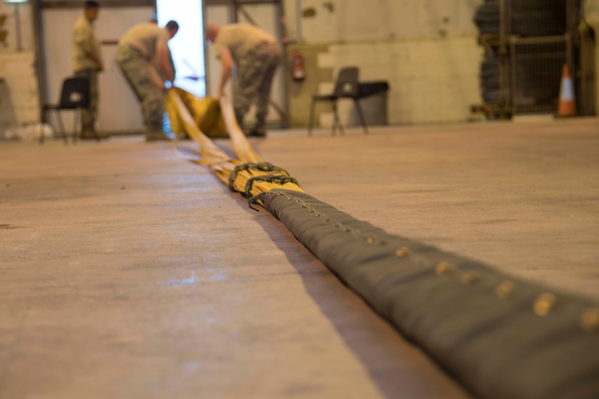 Citizen Reserve Airmen from the 307th Operations Support Squadron retrieve a drauge chute from a B-52 Stratofortress at RAF Fairford, England, Sept. 11, 2018.  The 307th Bomb Wing, along with three other Reserve units and one active duty unit, performed a unique dual mission, fulfilling both a Bomber Task Force requirement and participating in Exercise Ample Strike 18.   (U.S. Air Force photo by Master Sgt. Ted Daigle)