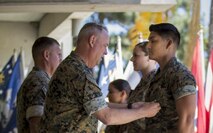 Sergeant Ashton D. Favela receives a Navy and Marine Corps Achievement Medal from Brigadier General  Kevin J. Killea for receiving Non Commissioned Officer of the Quarter.