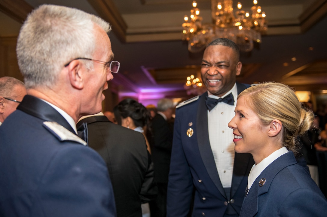 Selva greets Wilson and another service member.