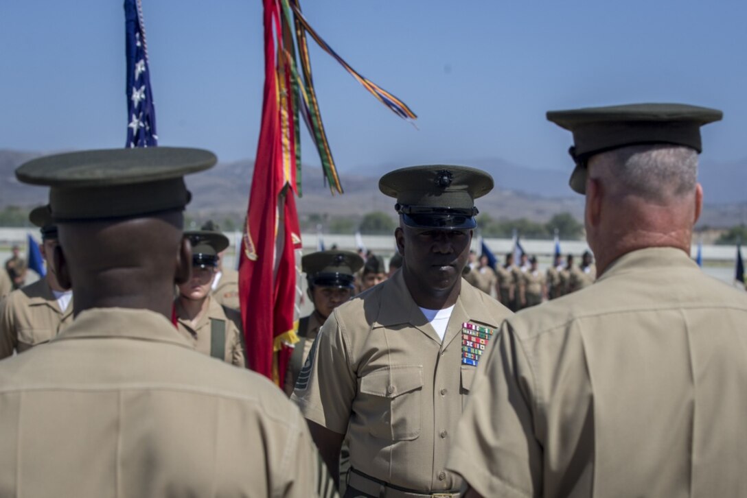 The outgoing Sergeant Major of Marine Corps Air Station Camp Pendleton, Sergeant Major Reginald Robinson, stands ready to be relieved on 11 June 2018 by Sergeant Major Dennis K. Campbell.