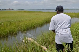 Jamaal Gatlin, 633rd Civil Engineer Squadron Heavy Equipment Operator throws a boom over the water Aug. 14, 2017, on Joint Base Langley-Eustis, Va.